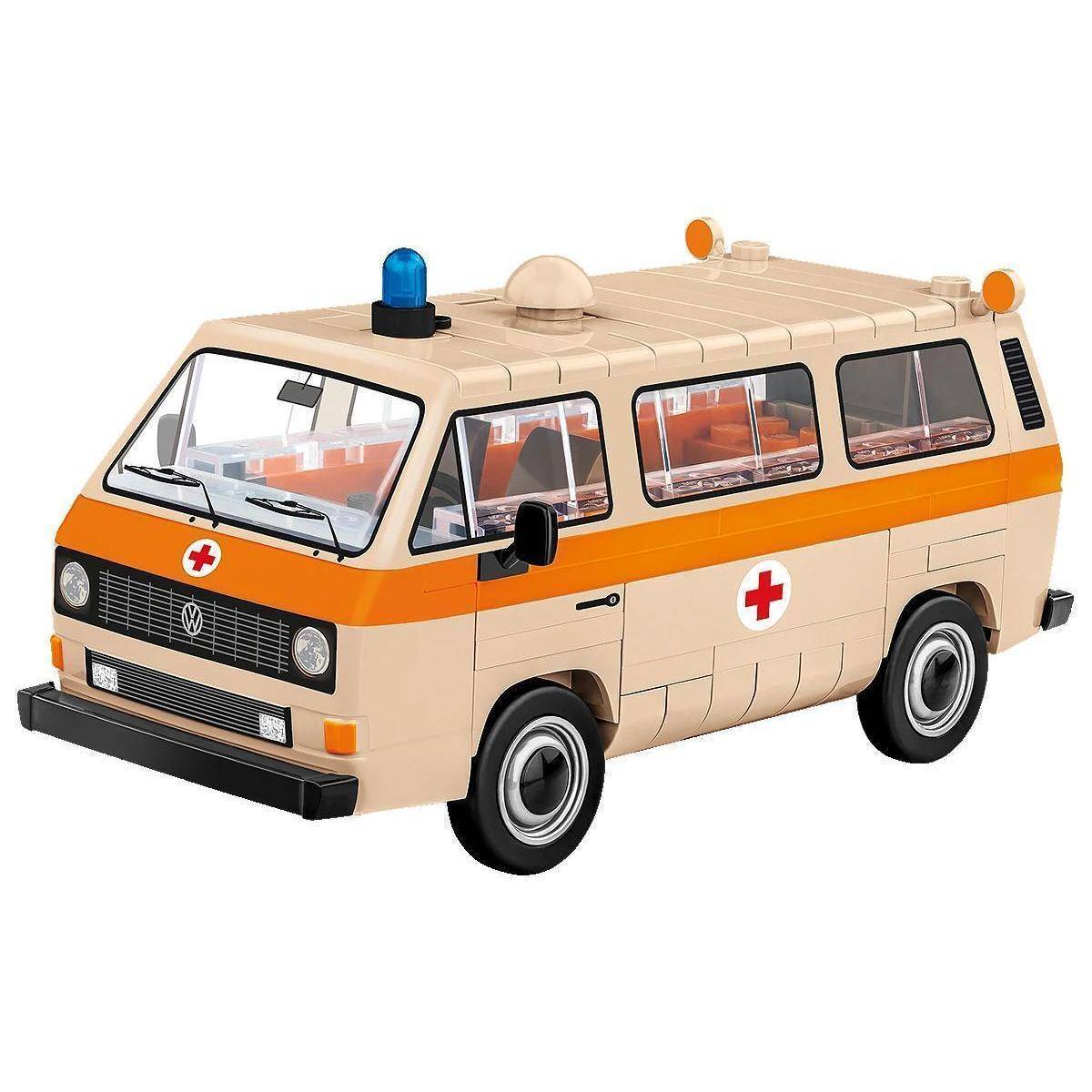 Ein Spielzeugkrankenwagen aus Bausteinen mit einem beige- und orangefarbenen Farbschema, das ein rotes Kreuz-Symbol und ein blaues Blaulicht oben aufweist.