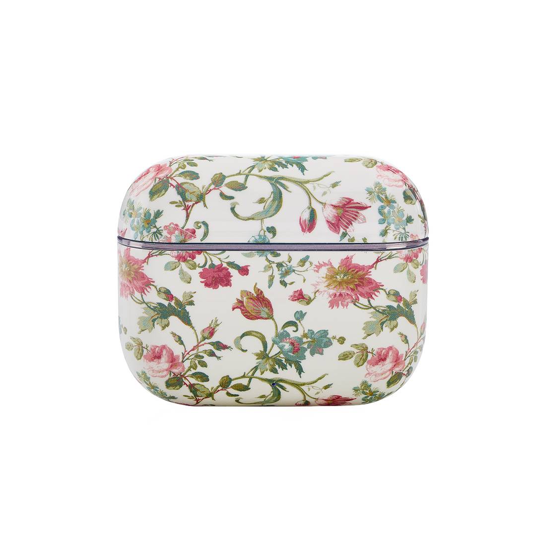 Dekorativer weißer Koffer mit Blumenmuster, mit rosa, roten und grünen Farbtönen.