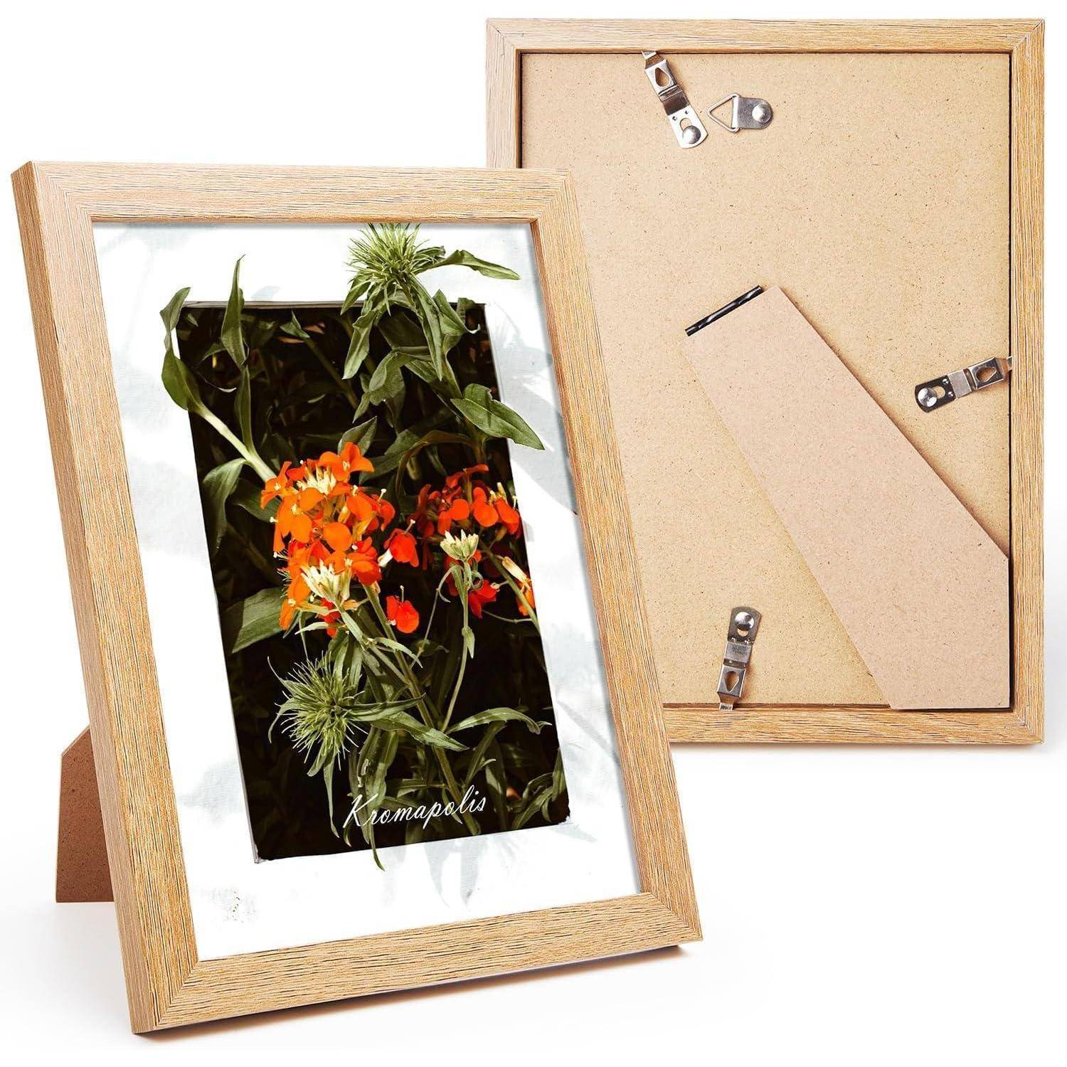 Ein Holzbilderrahmen, der ein Foto von leuchtend orangen Blumen mit der Bezeichnung „Knautia