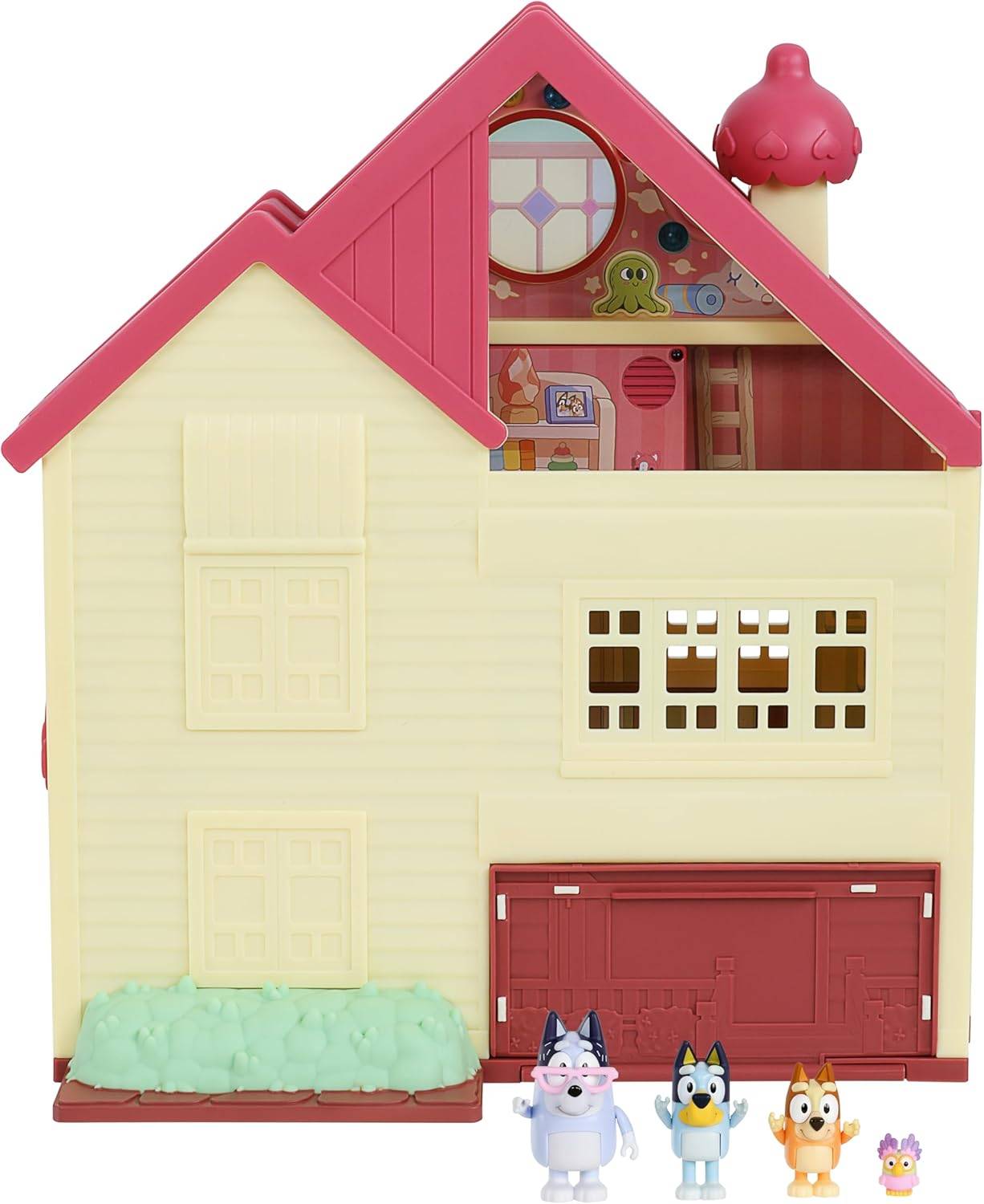 Ein Spielzeug-Puppenhaus mit gelber Fassade und rotem Dach, das einen inneren Spielbereich oben und Zeichentrickfiguren davor aufweist.