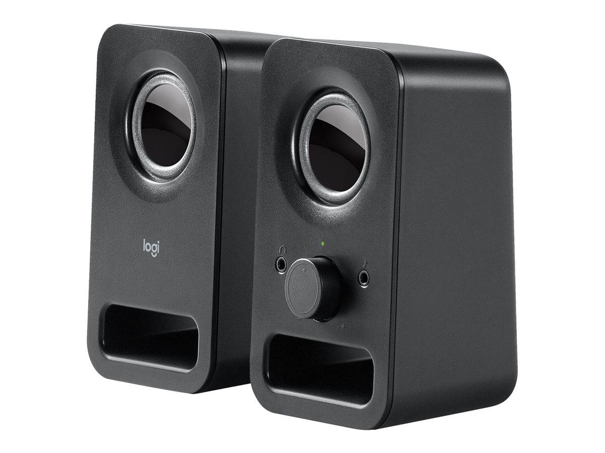 Paar schwarzer Logitech-Schreibtischboxen mit runden Treibern, vorderen Bassreflexöffnungen und einem kleinen Lautstärkeregler auf einem Lautsprecher.