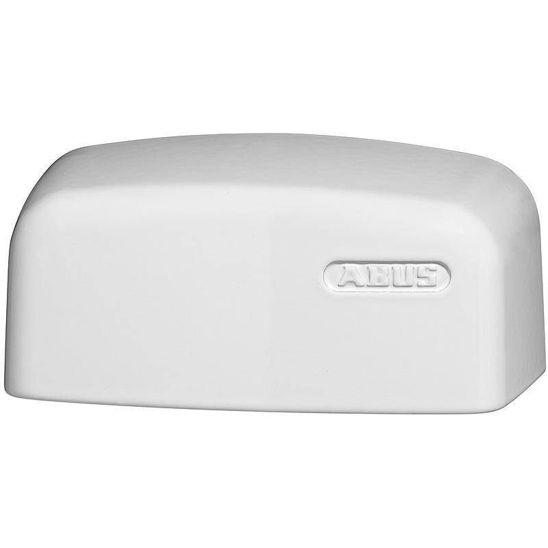 Ein weißes rechteckiges Objekt mit abgerundeten Kanten, das auf einer Seite geprägte Schrift aufweist. Das Objekt wirkt glatt und massiv.