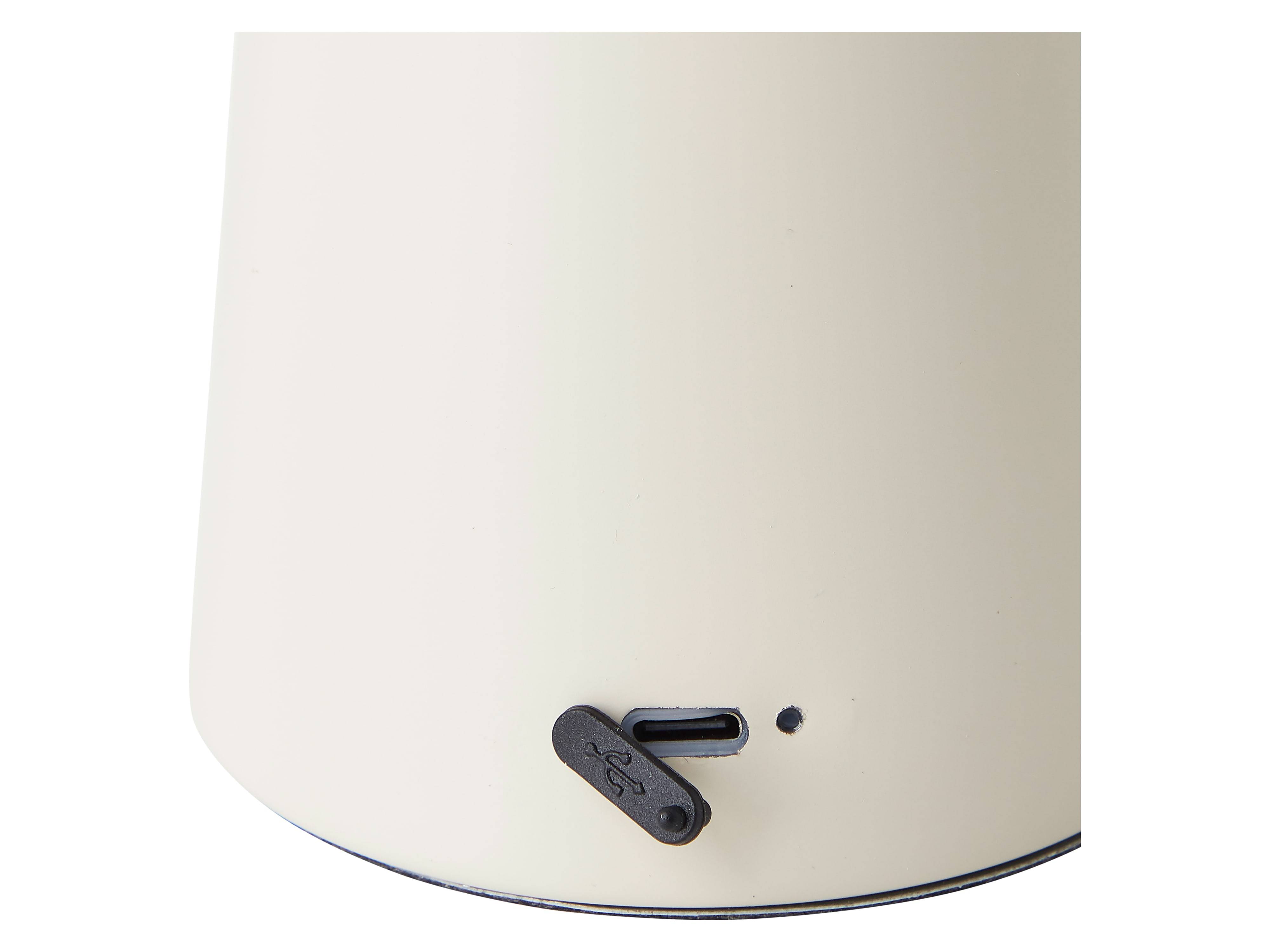 Eine Nahaufnahme eines beigen USB-Anschlusses eines Geräts auf einer glatten Oberfläche, möglicherweise auf der Unterseite eines kleinen Haushaltsgeräts oder elektronischen Gadgets.