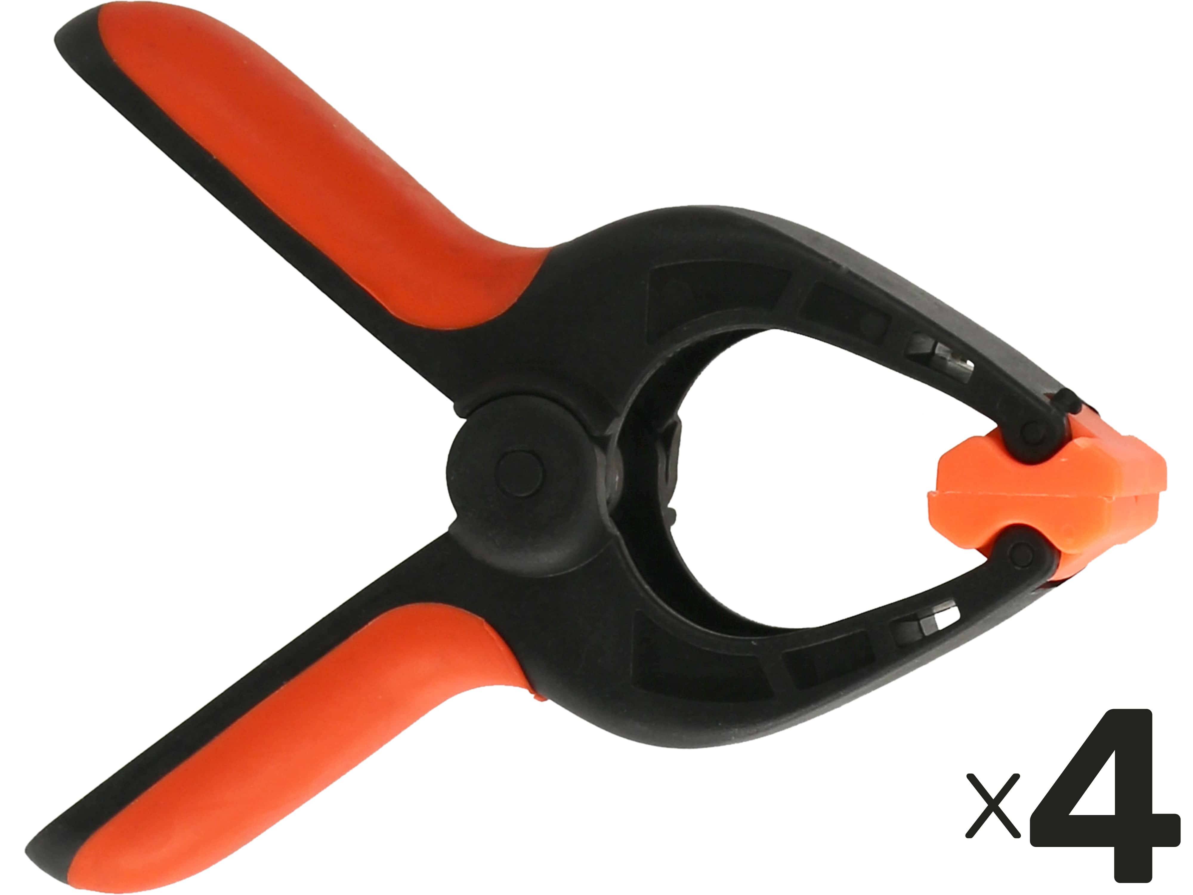 Eine schwarze und orangefarbene Kunststoffklemme mit schwarzem Griff, offen und von oben betrachtet, auf weißem Hintergrund mit einem kleinen 