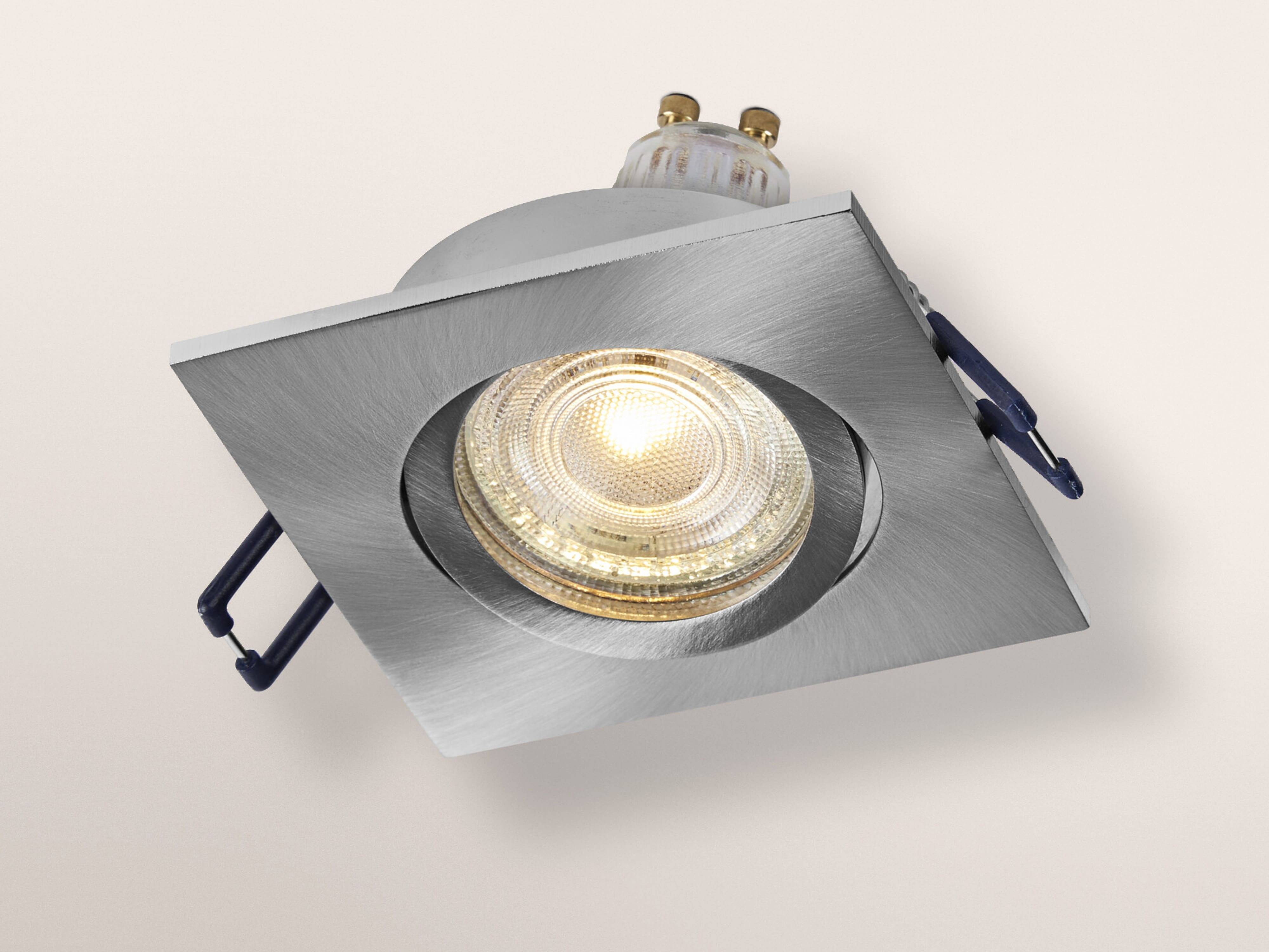 Ein quadratisches, bündiger Deckenleuchte mit einer kreisförmigen LED-Lampe in der Mitte, in einem leichten Winkel montiert, umgeben von einem metallischen Rahmen.