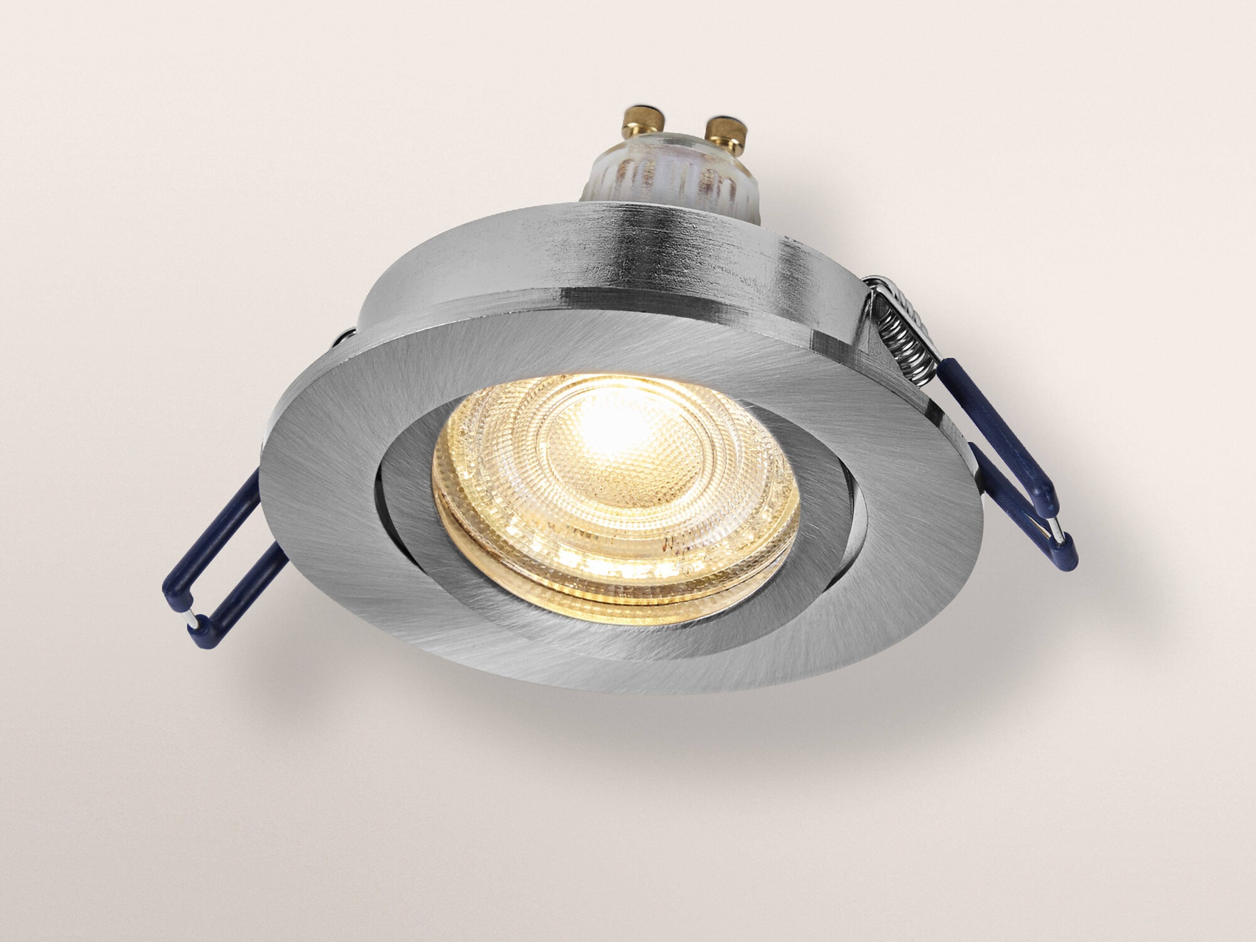 Eine runde, metallische Einbauleuchte mit leuchtender LED-Birne, entwickelt zur Deckeninstallation, mit verstellbaren Seitenclips.