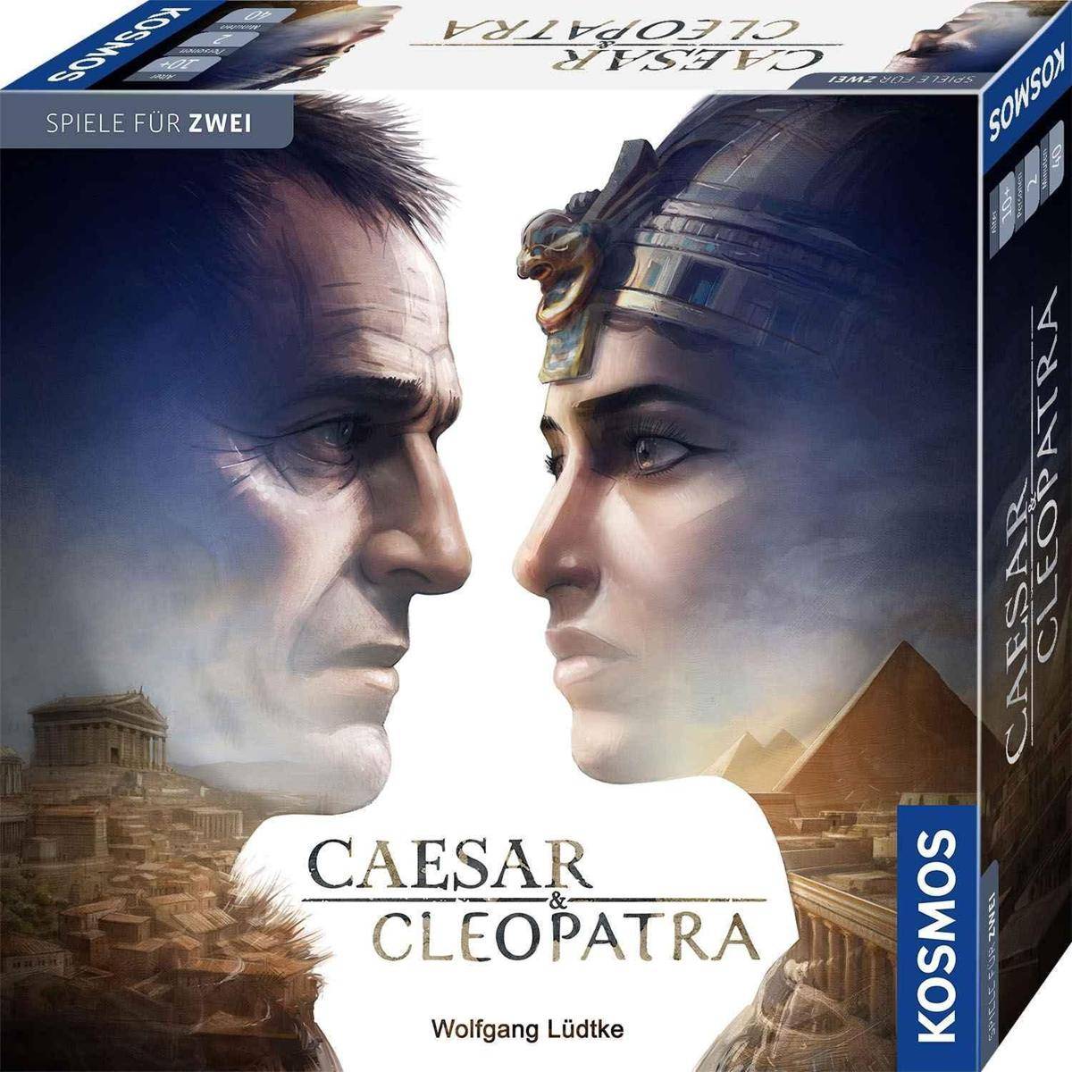Caesar & Cleopatra' Brettspiel-Schachtel mit Illustrationen der namensgebenden Charaktere, die sich gegenseitig gegenüberstehen, vor einem Hintergrund einer antiken Stadt.
