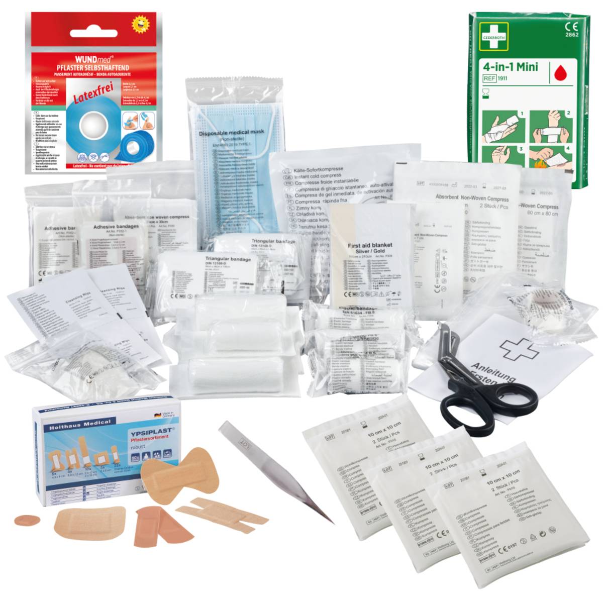Erste-Hilfe-Kasten-Inhalt einschließlich Verbandsmaterial, Schere, Pinzette, Heftpflaster, Gaze und Desinfektionstücher, ordentlich angeordnet.