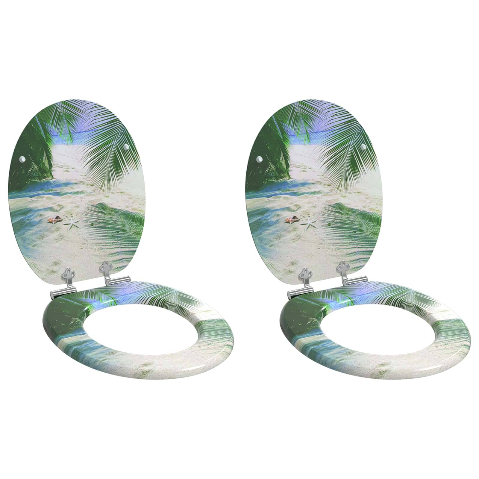Zwei Toilettensitze mit tropischem Stranddesign, das Palmblätter und Meereswellen zeigt und eine entspannende und friedliche Badezimmeratmosphäre schafft.