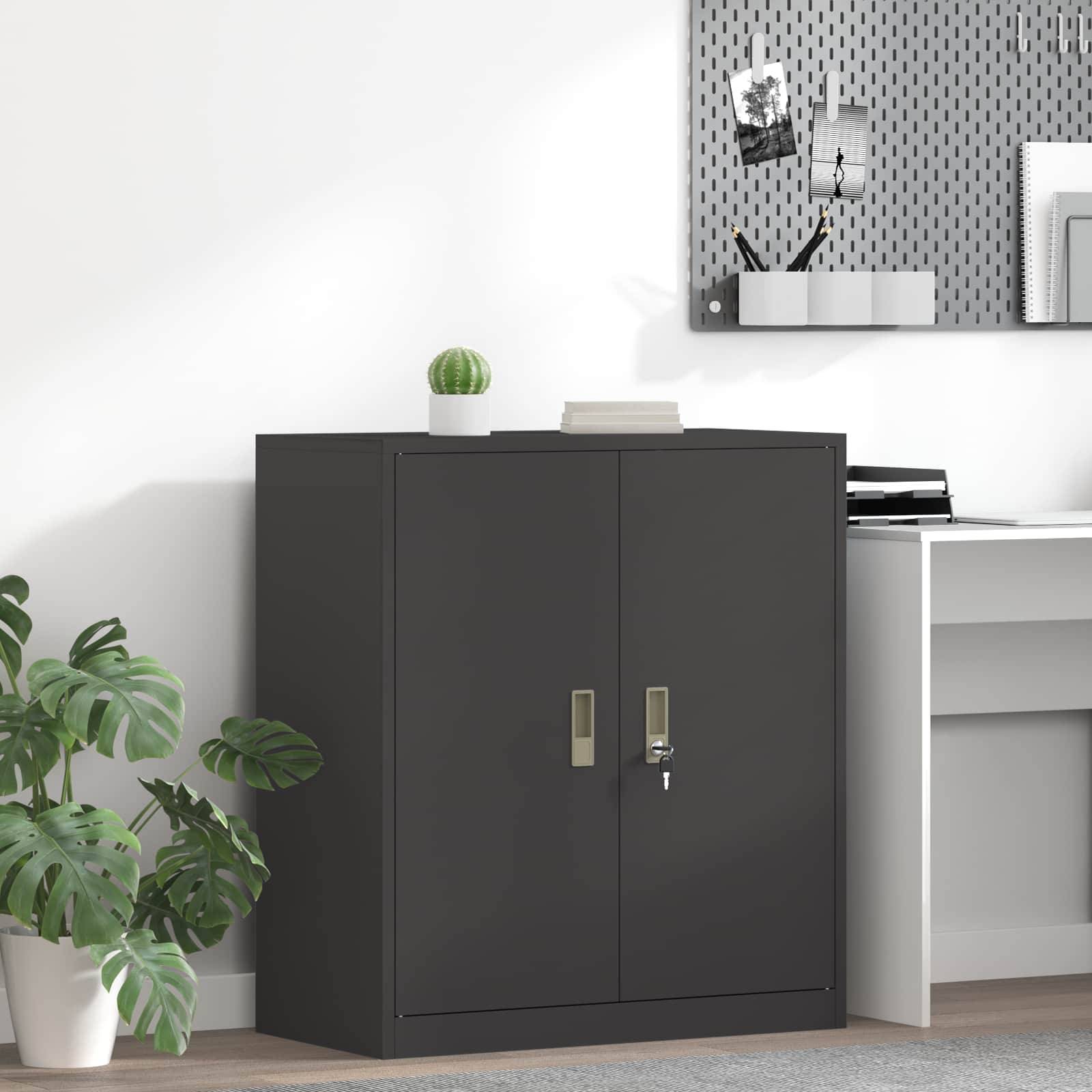 Eine moderne Büroecke mit einem weißen Schreibtisch, einer Topfpflanze und einem schwarzen Aktenschrank. Ein Pinnwand mit Fotos ist darüber angebracht.
