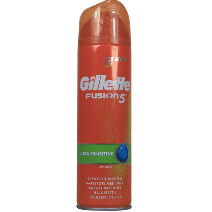 Eine orange Dose Gillette Fusion5 Ultra Sensitive Rasiergel mit Aloe, mit einem blauen Tropfensymbol und Text, der ein „dufttendes Rasiergel