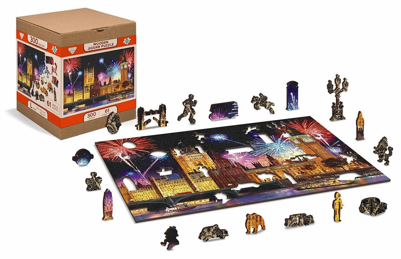 Ein teilweise vervollständigtes 300er-Puzzle zeigt eine Skyline einer Stadt und Feuerwerk. Puzzleteile und die Schachtel sind in der Nähe sichtbar.