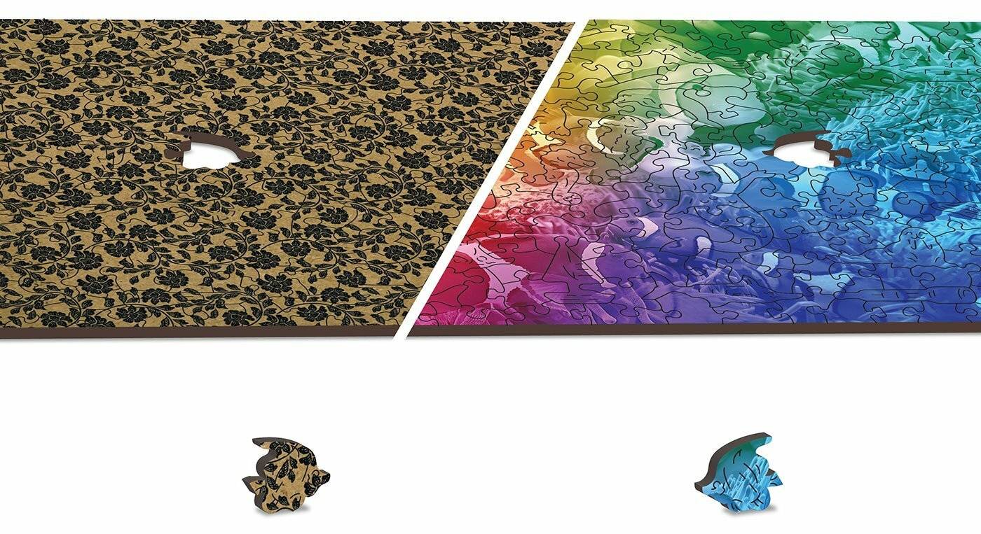 Ein teilweise zusammengesetztes Puzzle mit einem farbigen Farbverlaufsmuster, das von schwarzen Blütenmustern zu lebendigen Regenbogentönen übergeht.
