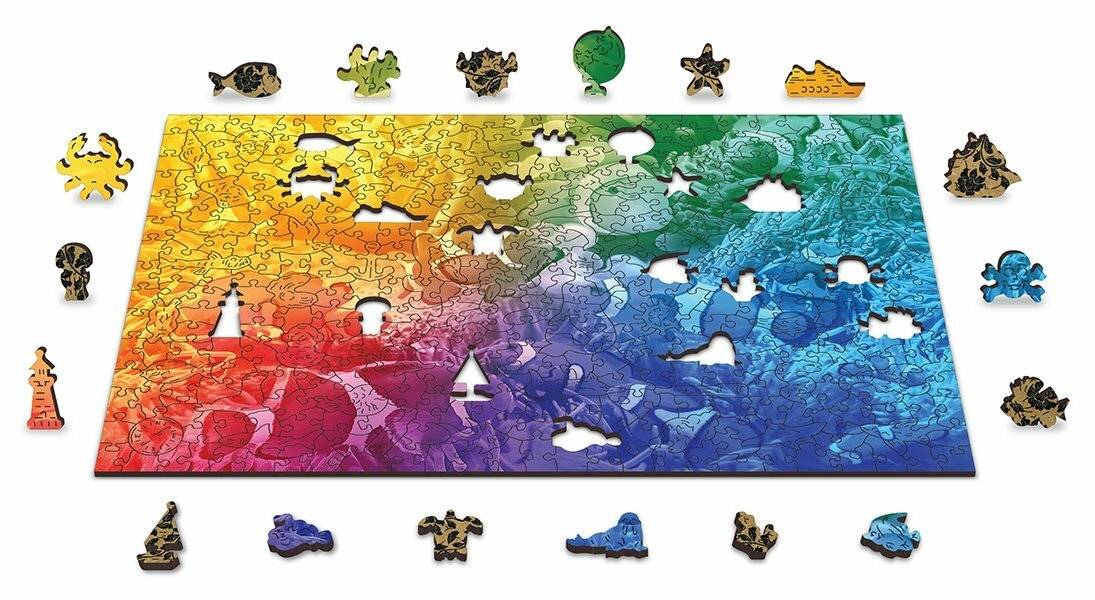 Ein buntes Puzzle mit einem Farbverlauf von Rot zu Blau. Verschiedene geformte Teile sind gelöst, darunter ein Stern und ein Ballon.