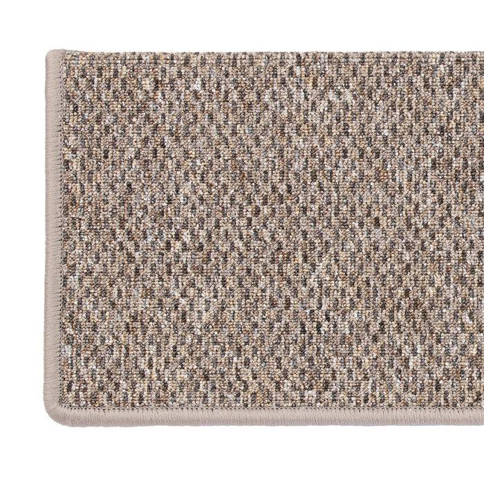 Eine rechteckige beige und braun gesprenkelte Fußmatte mit strukturierter Oberfläche, umrahmt von einem dicken beigen Rand.