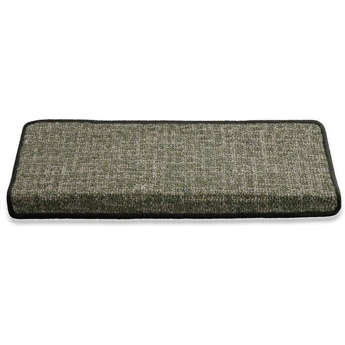 Eine rechteckige gepolsterte Matte mit einer strukturierten grauen Oberfläche und schwarzen Kanten, die zum Betreten oder Sitzen verwendet wird.