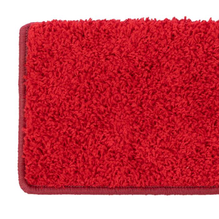Ein lebendiger roter rechteckiger Plüschteppich mit einer weichen, strukturierten Oberfläche, der sich ideal dazu eignet, Wärme und Farbe zur Inneneinrichtung hinzuzufügen.