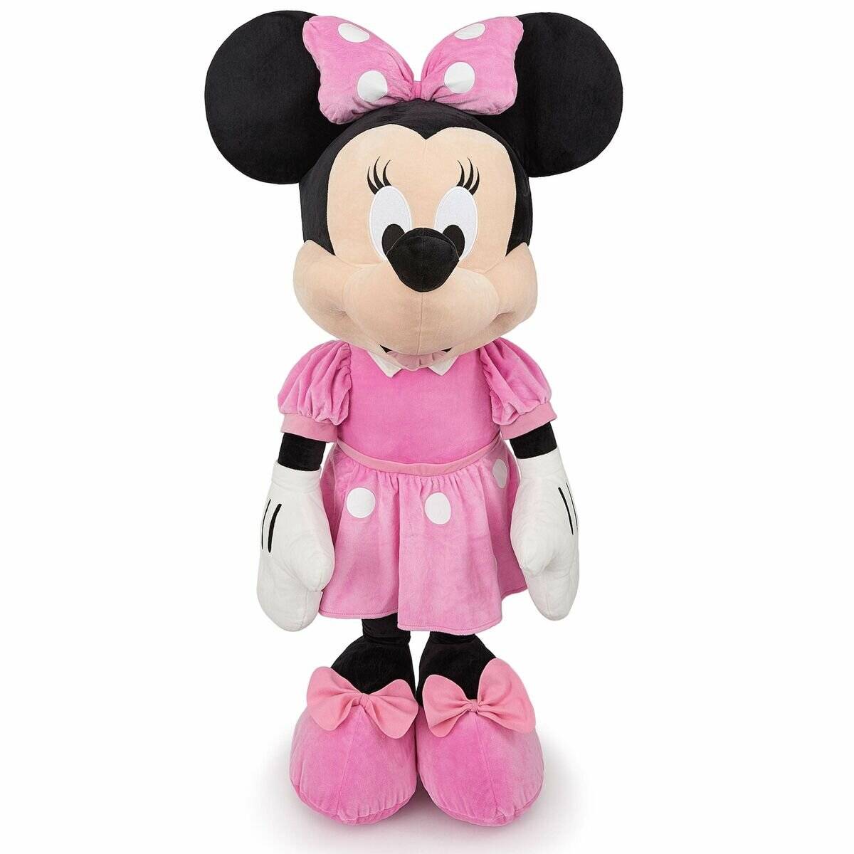 Ein Plüschtier der Minnie Mouse, das ein rosa Kleid mit weißen Punkten trägt, eine passende Schleife auf dem Kopf hat und rosa Schuhe mit Schleifen trägt.