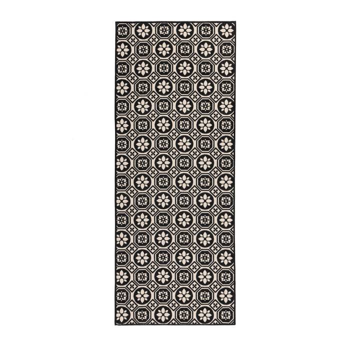 Läufer mit geometrischem Muster aus Achtecken mit floralen Motiven auf schwarzem Grund.