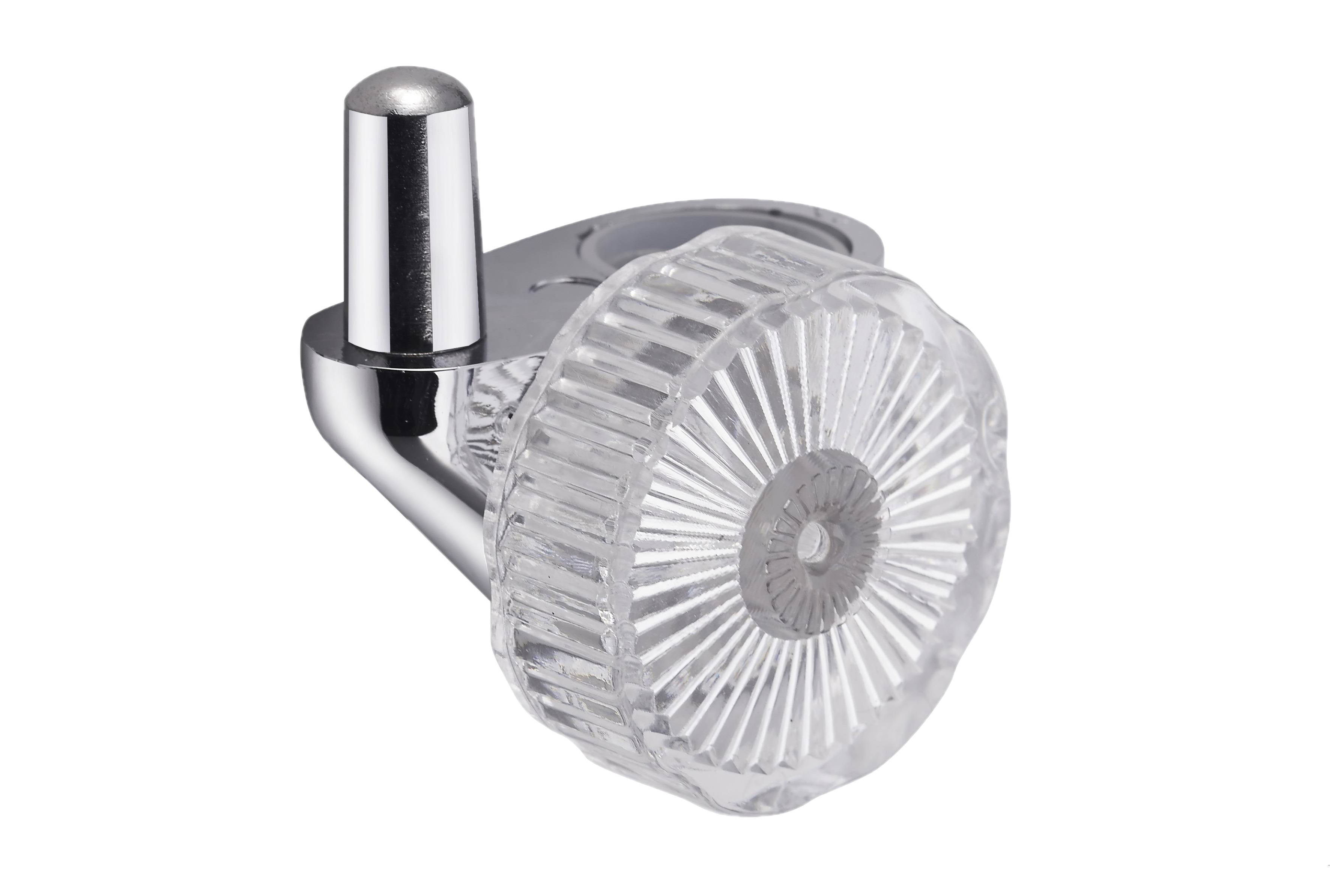 Türknopf aus Chrom und klarem Kunststoff mit verzierter, gerippter, sonnenstrahlenmusterförmiger runder Fläche auf einer Metallhalterung.