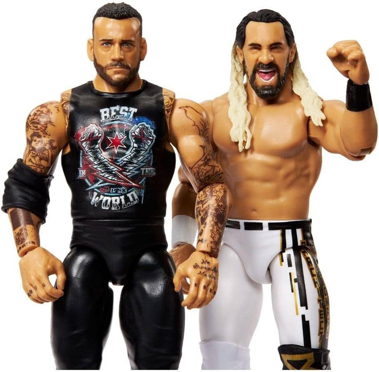 Zwei detaillierte Wrestling-Actionfiguren. Eine hat kurze Haare, einen Bart und ein schwarzes Outfit mit Tätowierungen. Die andere hat lange blonde Haare und weiße Hosen.