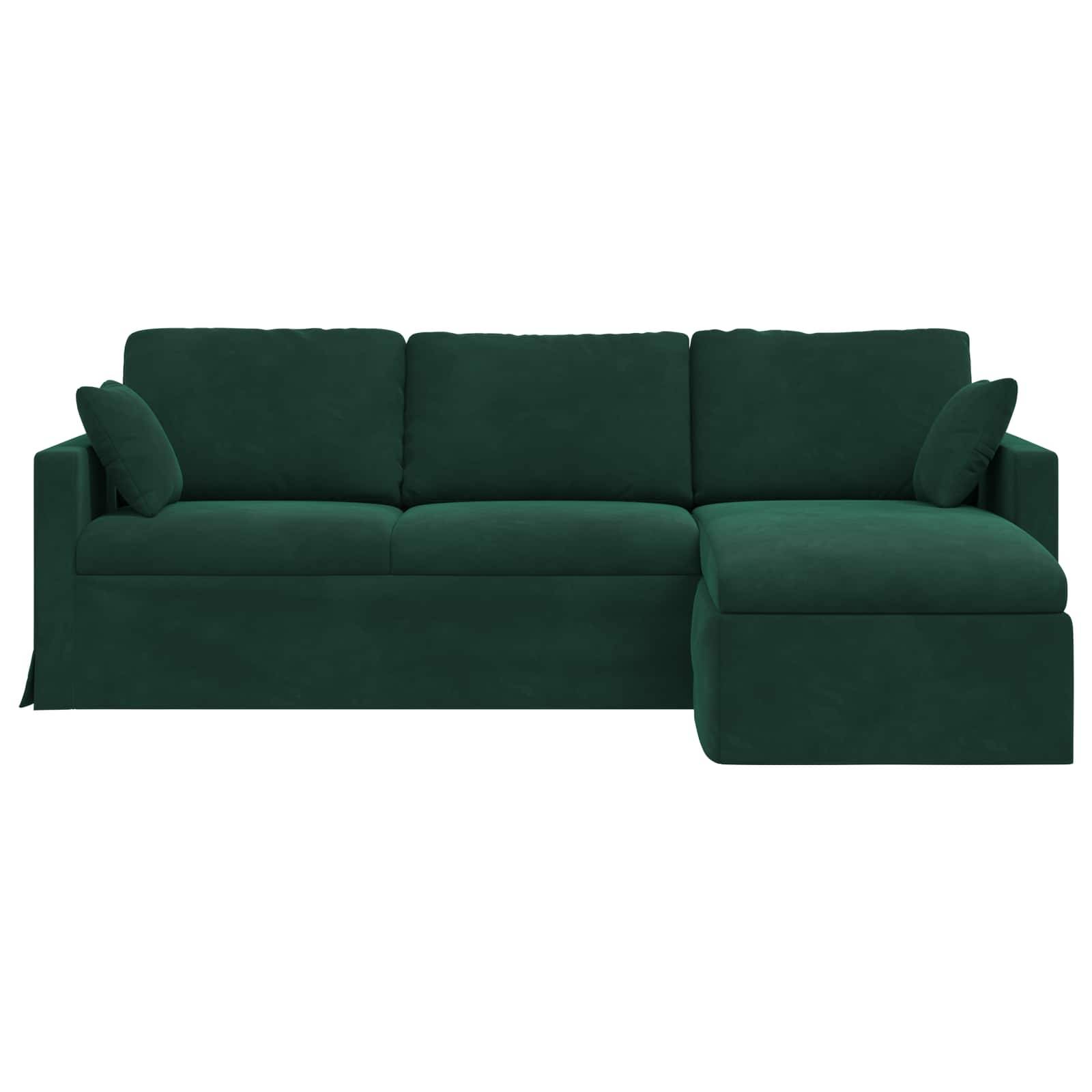 Ein grünes Ecksofa mit drei Sitzkissen und einer Recamiere auf der rechten Seite, das zwei dekorative Kissen hat.