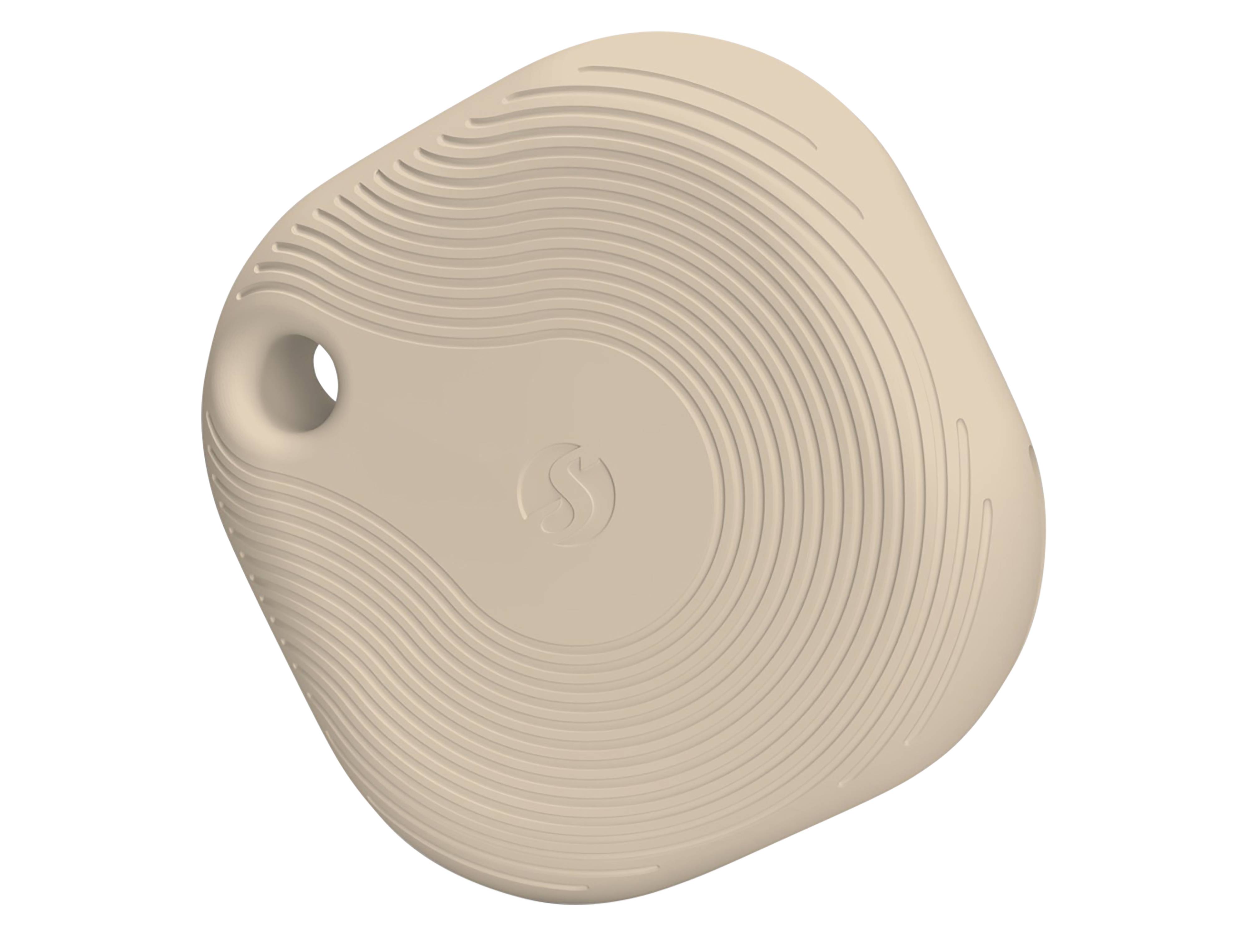 Ein kleines beiges Ortungsgerät mit einem Loch zur Befestigung und einem strukturierten Wellenmuster auf der Oberfläche.