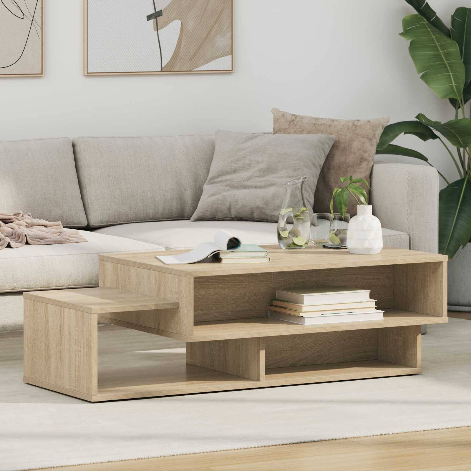 Ein modernes Wohnzimmer verfügt über ein beiges Sofa mit weichen Kissen, einen hölzernen Couchtisch mit Büchern und einer Pflanze sowie abstrakte Kunstwerke an der Wand.