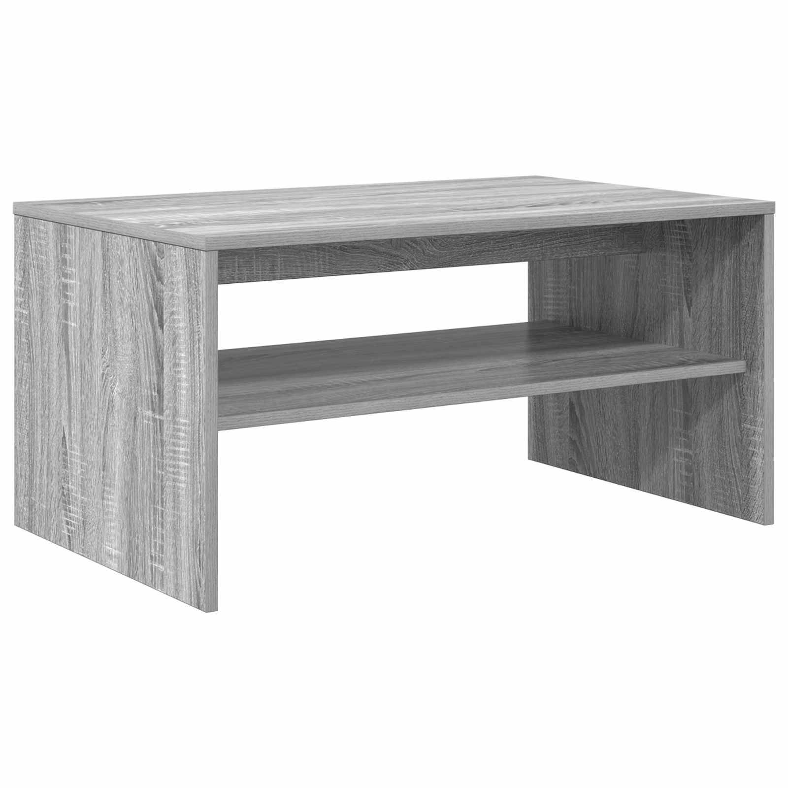 Ein einfacher rechteckiger grauer Holzkaffeetisch mit einem offenen Regal unterhalb der Tischplatte.