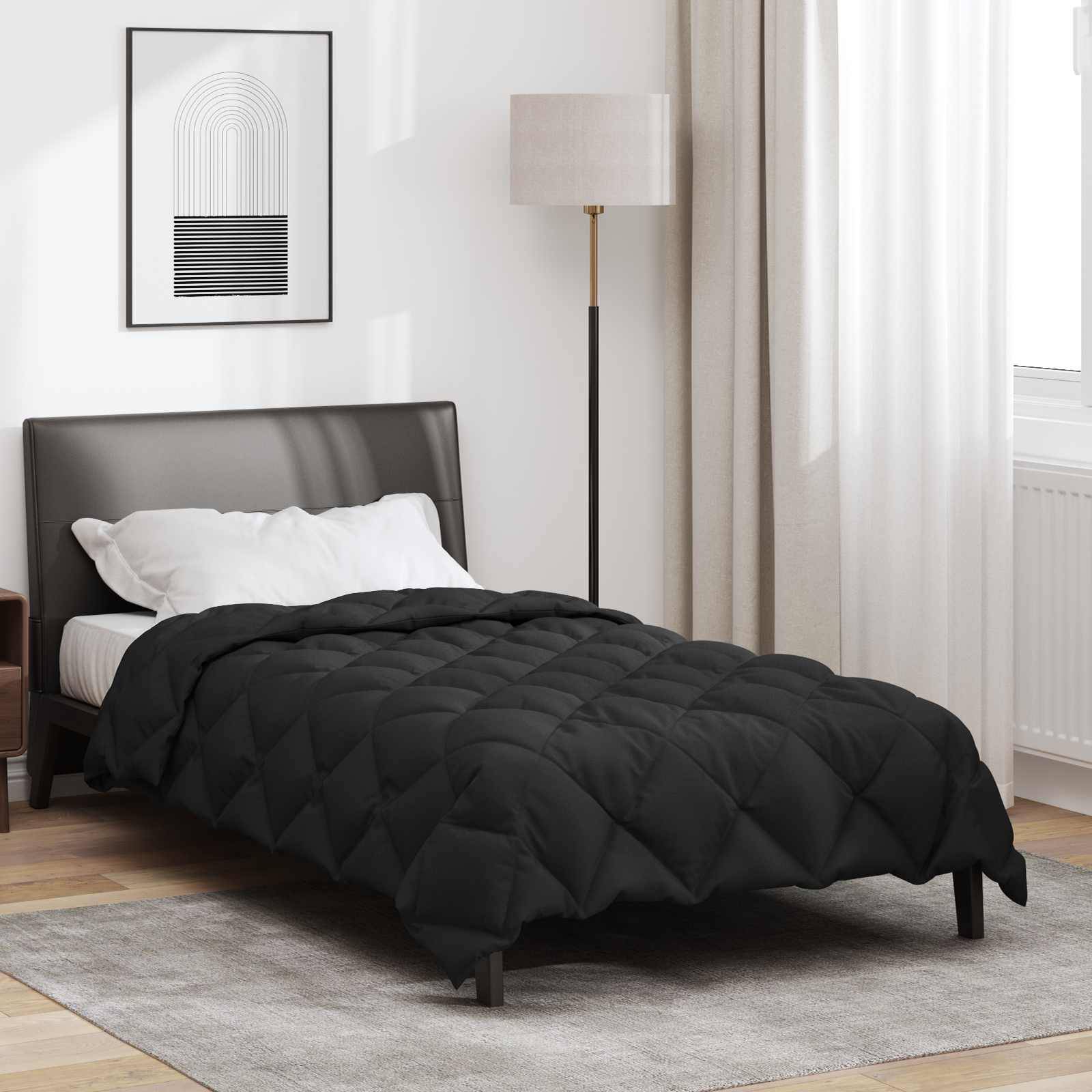 Ein modernes Schlafzimmer mit einem schwarzen Steppbett, einer hohen Stehleuchte und einem minimalistischen Kunstwerk an der Wand. Elfenbeinfarbene Vorhänge hängen neben einem Fenster.
