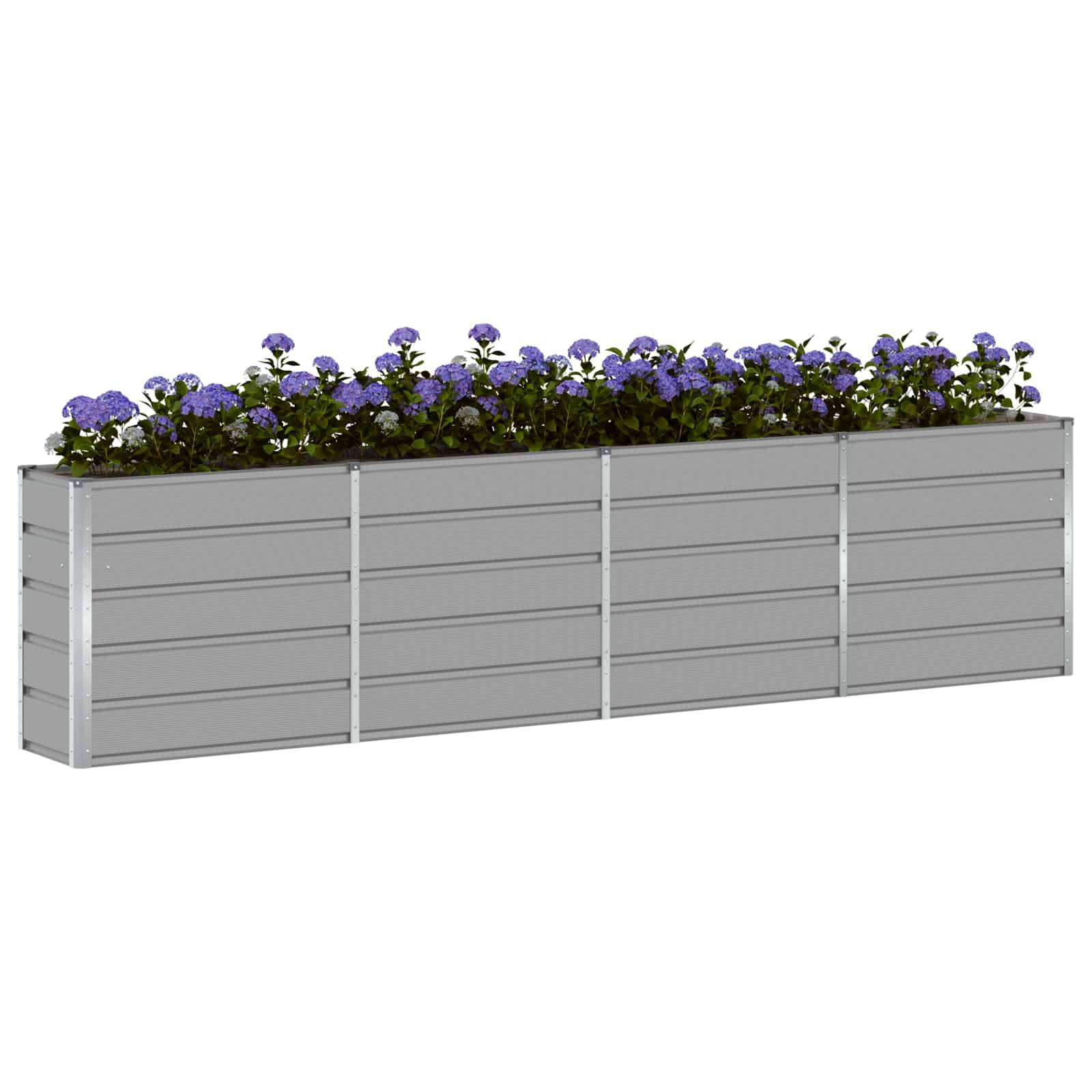 Ein rechteckiger Metallblumenkübel gefüllt mit kleinen violetten Blüten und grünem Laub.