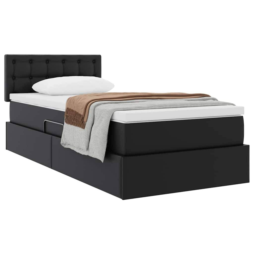 Schwarzes gepolstertes Bett mit knopfgestepptem Kopfteil, mehrschichtige Matratze und Kissen. Braune und graue Decken am Fußende gefaltet.