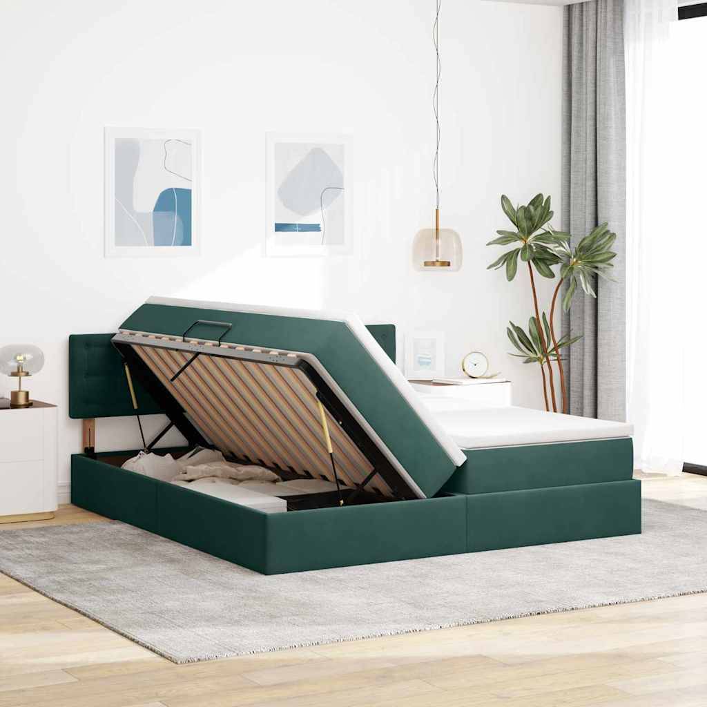 Ein modernes Schlafzimmer mit einem grau gepolsterten Bett mit angehobenem Stauraum. Das Zimmer verfügt über weiße Wände, abstrakte Kunst und eine Topfpflanze.