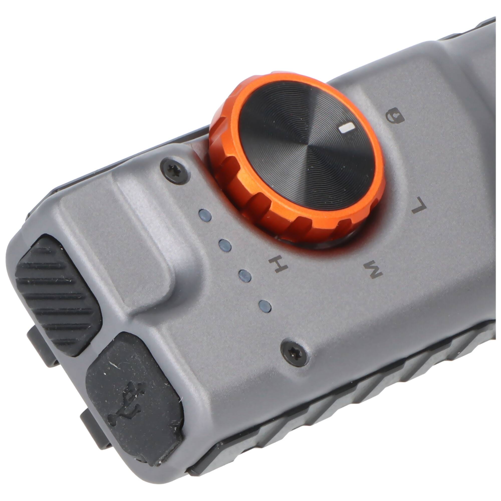 Eine Nahaufnahme eines tragbaren Geräts mit einer kreisförmigen orangefarbenen Skala mit Einstellungen, die mit „H