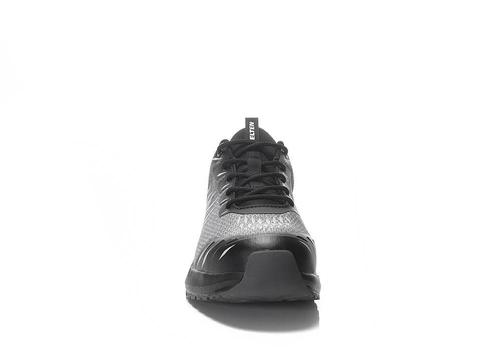 Ein grauer und schwarzer Sportschuh, von vorne betrachtet, mit Maschenmuster-Design und strukturierter Sohle, mit einem Etikett mit der Aufschrift „ELTEN