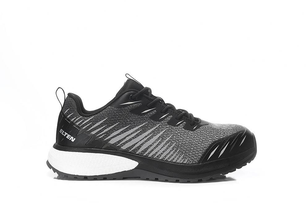Ein schwarzer und grauer Sneaker mit weißer Sohle und der Marke 