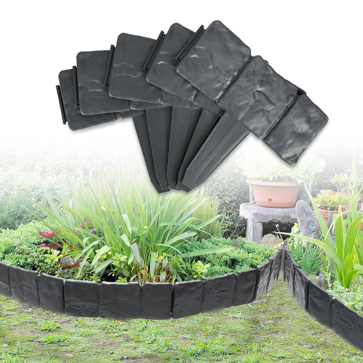 Garteneinfassung mit schwarzen Steinen, die sich geschwungen um ein üppiges Blumenbeet mit verschiedenen Pflanzen erstreckt und eine saubere und ordentliche Trennung schafft.