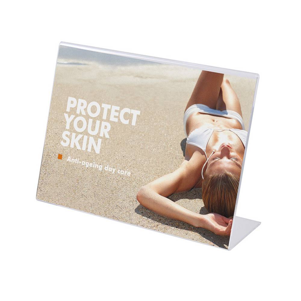 Eine Frau in einem weißen Bikini liegt entspannt im Sand in der Sonne. Der Text lautet: „Schützen Sie Ihre Haut - Anti-Aging-Tagespflege.