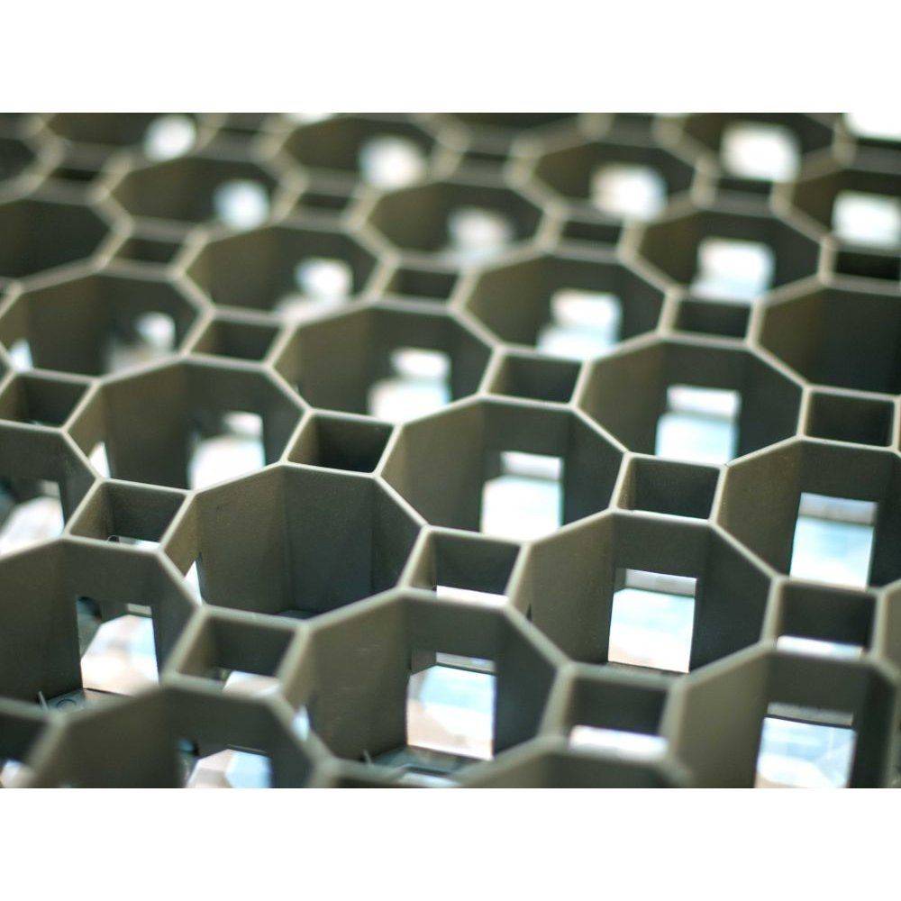 Eine Nahaufnahme einer wabenartigen Gitterstruktur, die sechseckige Zellen zeigt, mit Licht, das von hinten durchfiltert.