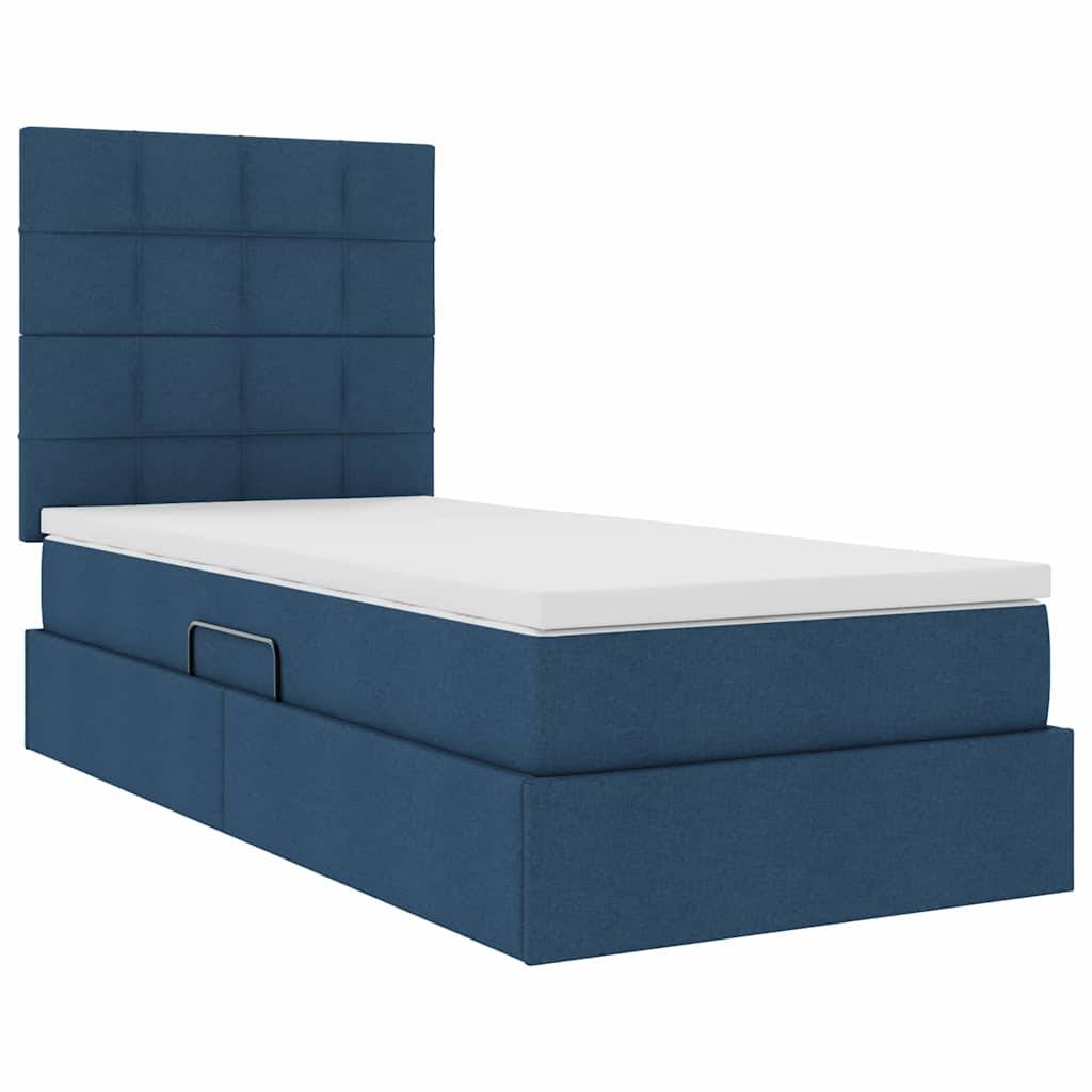 Blaues gepolstertes Plattformbett mit einem hohen gepolsterten Kopfteil und einer weißen Matratze oben.