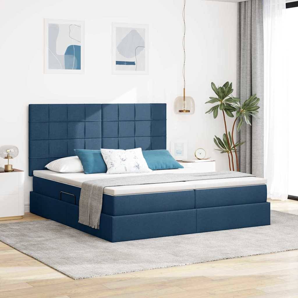 Ein modernes Schlafzimmer verfügt über ein blau gepolstertes Plattformbett mit weißer Bettwäsche, einer grauen Wurfdecke und dekorativen Kissen. Eine Topfpflanze und abstrakte Wandkunst verleihen stilvolle Akzente.