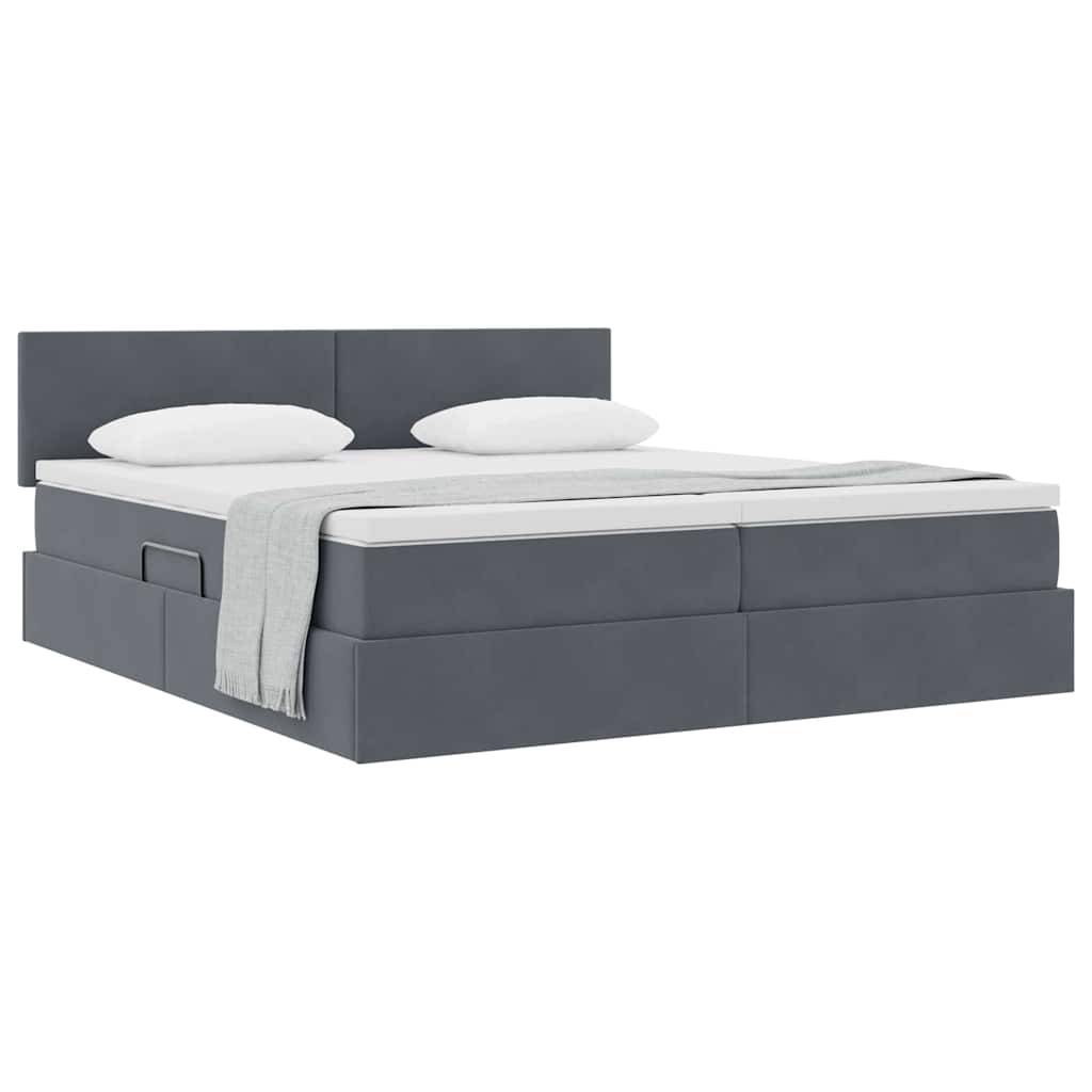 Ein grau gepolstertes Bett mit modernem Design, ausgestattet mit einem Kopfteil, zwei Kissen und einer ordentlich gefalteten Decke am Fußende.