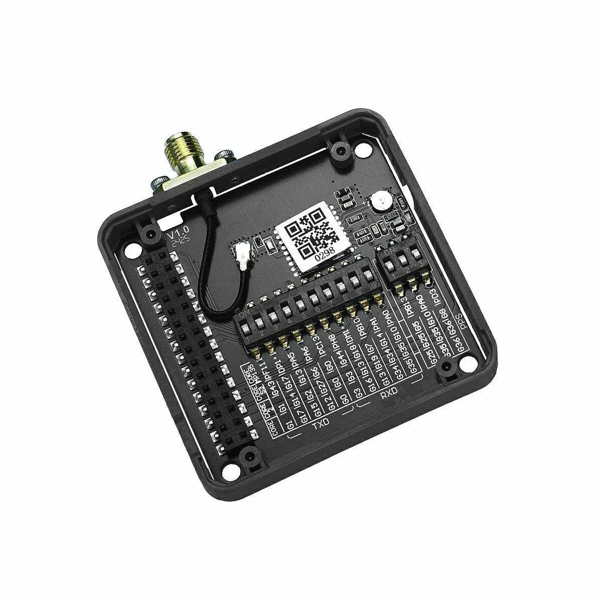 Ein kleines elektronisches Leiterplattchen mit einem QR-Code, Steckverbindern und beschrifteten Pins, wahrscheinlich zur Gerätesteuerung oder Datenübertragung.