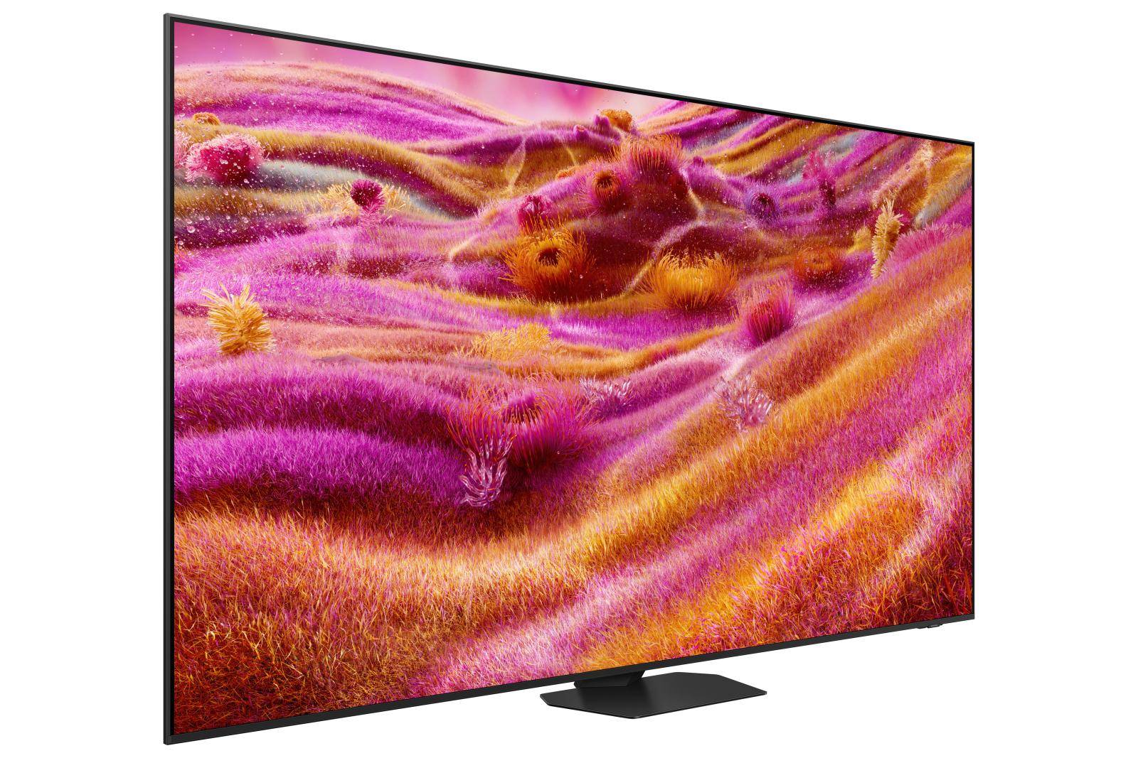 Ein lebendiger Fernsehbildschirm zeigt eine farbenfrohe abstrakte Landschaft mit sanften Hügeln in Rosa- und Orangetönen, die einer Traumlandschaft ähnelt.