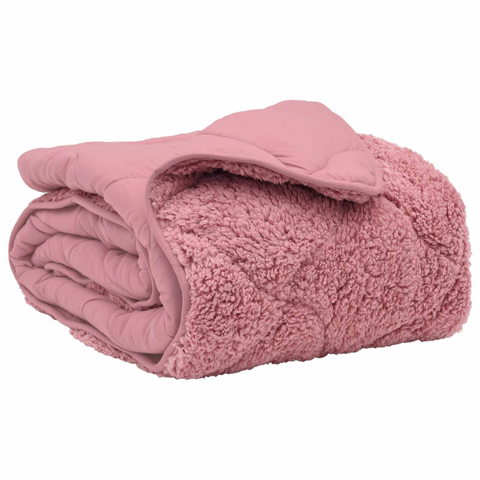 Eine gefaltete, plüschige rosa Decke mit gestepptem Muster auf einer Seite.