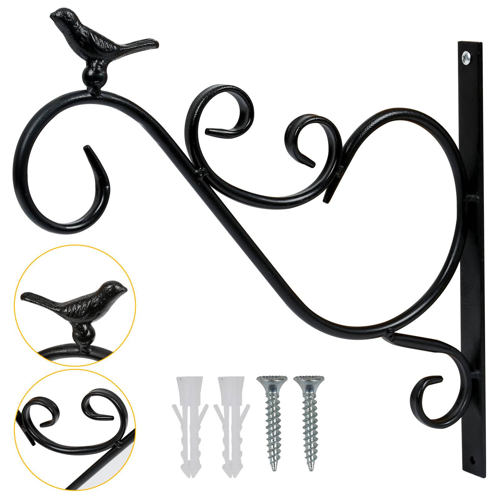 Eine dekorative schwarze Metallhalterung mit Vogelmotiv, begleitet von Schrauben und Wandankern zur Montage.