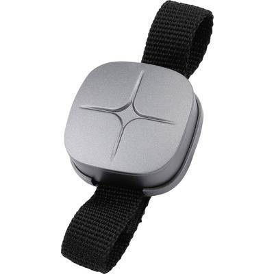 Ein kleines, graues Gerät mit einem Kreuzmuster oben, angebracht an einem schwarzen verstellbaren Riemen, möglicherweise ein tragbarer Sensor oder Gadget.
