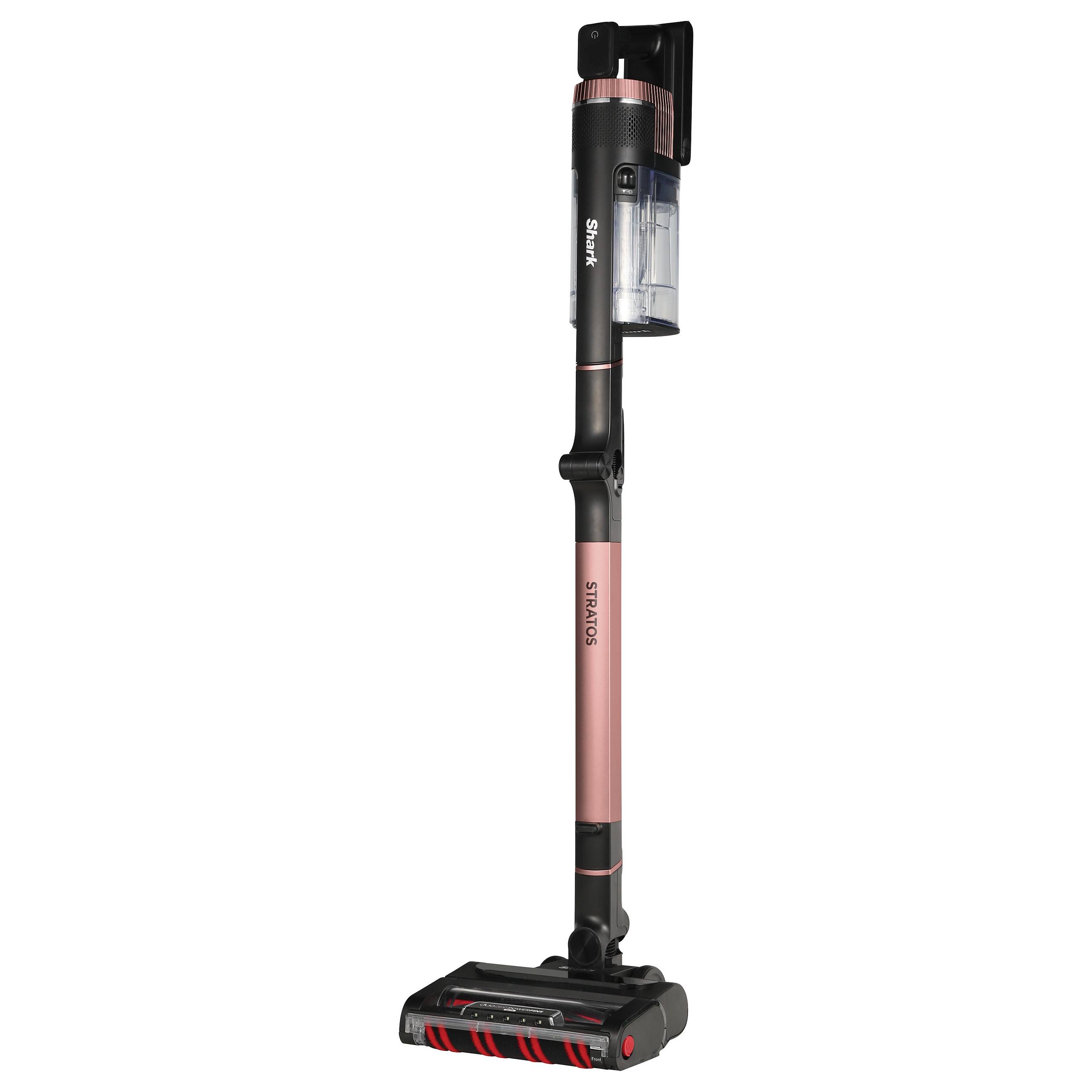 Kabelloser Staubsauger in aufrechter Position mit rosa-schwarzem Design, transparentem Staubbehälter und motorisierter Bürstenwalze.