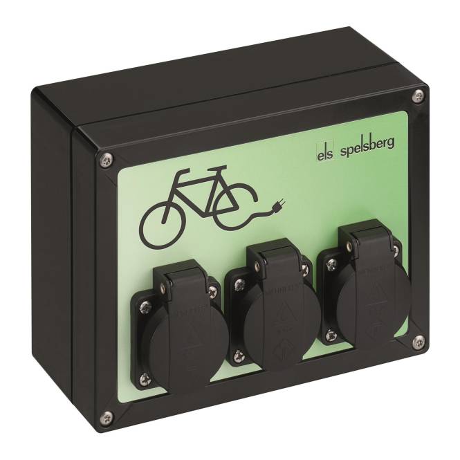 „Ladestation für E-Bikes mit drei Steckdosen auf einem grünen Panel, gekennzeichnet mit einem Fahrradsymbol und dem Text ‚els spelsberg'.