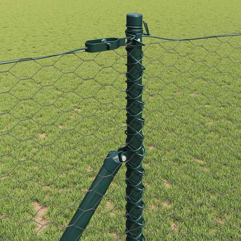 Ein Metallzaunpfosten trägt ein Maschendrahtgeflecht und sichert eine Grenze auf einem Grasfeld.